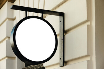 Mock up. Empty white round signage on the wall of classical architecture building in city