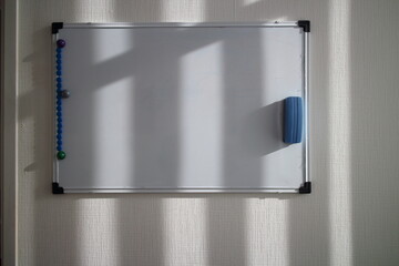 White magnetic drawing board on the wall