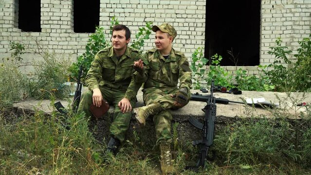 two soldiers made a halt, chatting and drinking