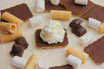 chocolate dessert with cream, chocolate sweets and waffles, cream cake among sweets.