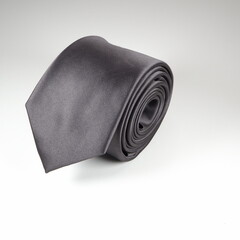 A black tie isolated on a white background close-up view single object 