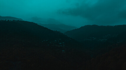 Mountains covered with trees under blue sky