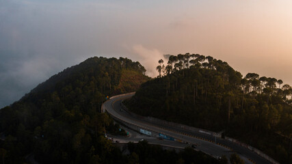Aerial view of beautiful homes in green hills surrounded by trees 
