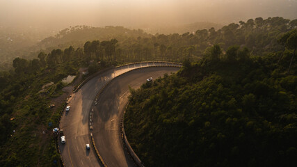 Aerial view of road in the middle of green mountains
