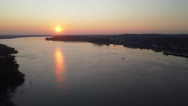 Golden sunset over vast river Scheldt in Belgium, aerial drone view