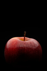 Macro photography of a red apple on a black background