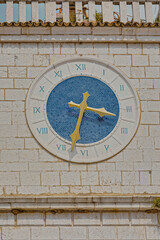 Blue clock at old stone house in Cres Croatia