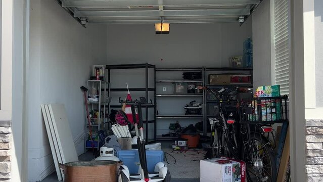 An unorganized garage filled with a lot of stuff in a neighborhood.