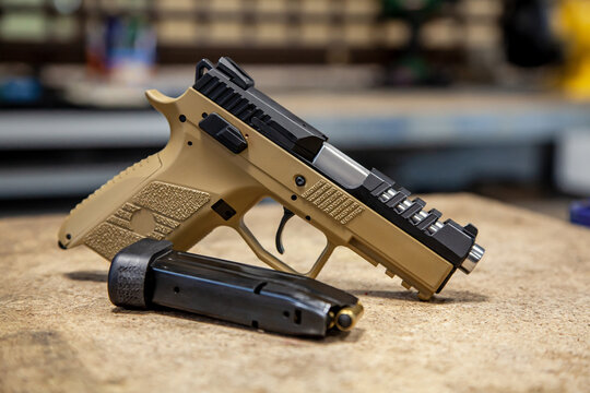 Modern traumatic pistol. Non-lethal short-barreled weapon for self-defense. Light back.