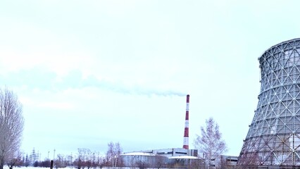 Gas combined heat and power plant with huge pipes, smoke, steam, power stations.