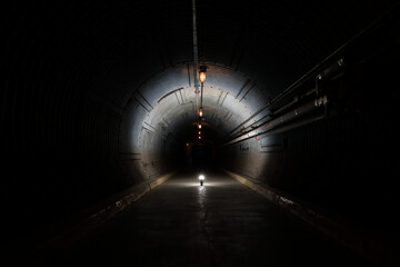 Long underground concrete corridor in a bunker tunnel