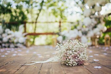 Tender gypsophila bouquet with white and pink colors on the wooden background. Bride bouquet.