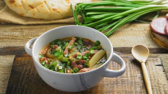 jewish cuisine bean soup cholit in the background bread and green onions