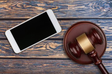 Blank screen seen on a smartphone and judge gavel.
