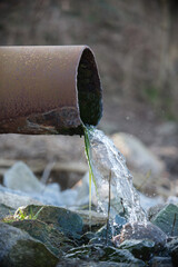 rostiges Rohr aus dem Wasser kommt