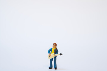 Miniature saxophonist playing music on a white background - copy space