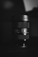 Vertical shot of a sigma 24-70 f2.8 lens in grayscale