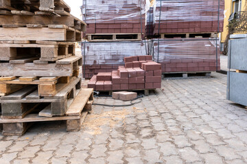 Storage of new paving slabs on pallets at the construction site. Repair of the sidewalk in the city. Reconstruction of urban infrastructure for a comfortable life