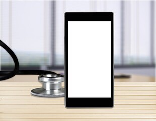 Online doctor concept. Phone with medical stethoscope.