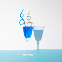Tasty Blue Lagoon cocktail on pastel blue and white background. Summer, beach or nightlife concept.
