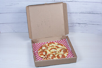 Traditional tomato, cheese, oregano pizza on red checkered napkin