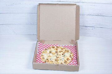 Traditional pizza with mushrooms, with cheese, pomodoro pasta on checkered napkin