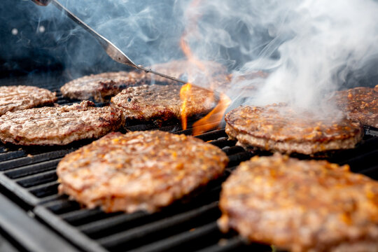 Closeup of the juicy burger meat being grilled on the grill