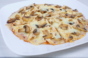 Traditional pizza with mushrooms, with cheese, pomodoro pasta on checkered napkin