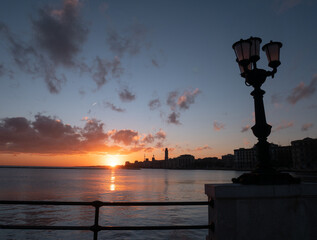 Bari, Lungomare, sorgere del sole nella bellissima città, silhouette profilo scuro nero, Sud,...