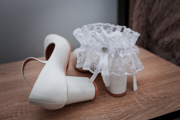 White shoes and bridal garter. Bride morning. Bride's accessories