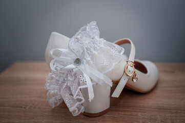 White shoes and bridal garter. Bride morning. Bride's accessories