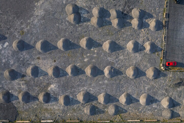 Aerial top down view on a piles of sand. Round shape. Construction material storage.