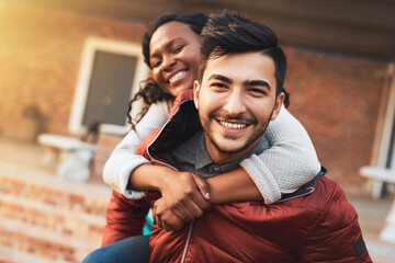Obraz premium After we graduate Im going to marry her. Portrait of a happy young couple enjoying a piggyback ride on campus.