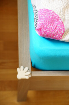 Hand-shaped Baby Proofing Corner Guard On A Bed