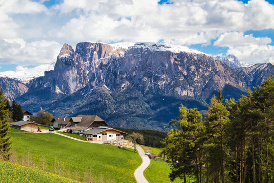 High angle of an Italian village on the hill with the background of mountain Schlern