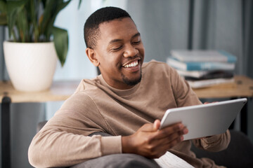 Get instant access to all the movies, music and games you want. Shot of a young man using a digital tablet at home.