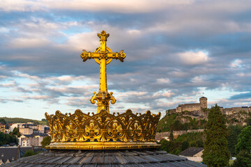 Gilded crown with a cross in front of the Basilica of Lourdes