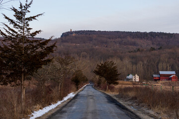 Straight road through brown rural countryside in late winter