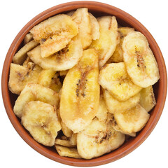 Dried banana chips in a brown ceramic bowl. Yellow fried banana slices, covered with sugar or honey.