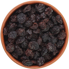 Black Raisins in a brown ceramic bowl isolated on white background.