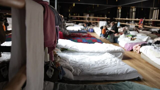 Volunteer work at the humanitarian aid warehouse. Rear town life during war Russian invasion in Ukraine. Refugees bedroom. Humanitarian catastrophe during at war in Ukraine.