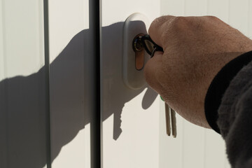 detail of a man opening an office door with colored keys concept of opening doors
