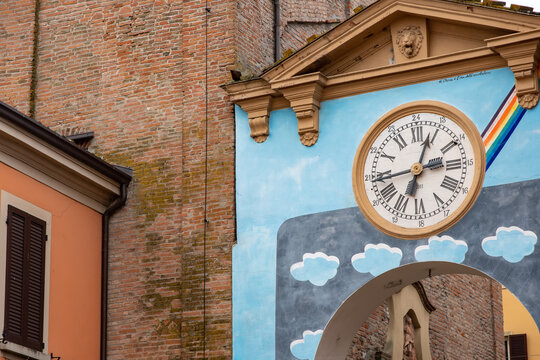 Ancient clock on the arched entrance door to the city of Dozza, famous for its artistic murals, in the province of Bologna