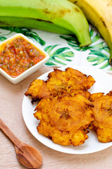 
Patacones or fried tostones of green or ripe plantain, with a crispy texture, accompanied by a tomato and onion stew called 
