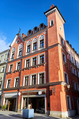 facade of historic tenement house with tower in the city of Poznan