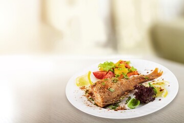 Fried salmon with vegetableson plate. Sprinkled with sesame seeds.