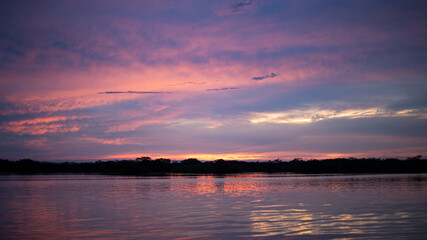 Beautiful background of an purple evening sky over a lake in Cuyabeno, the Amazon in Ecuador, South America