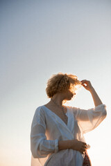 woman blonde in white blouse on sunset