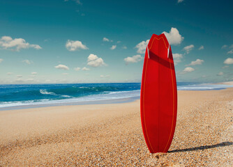 Beautiful beach with a red surfboard in the sand