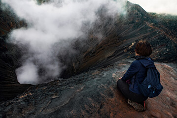 girl looking into the crater of the volcano Bromo